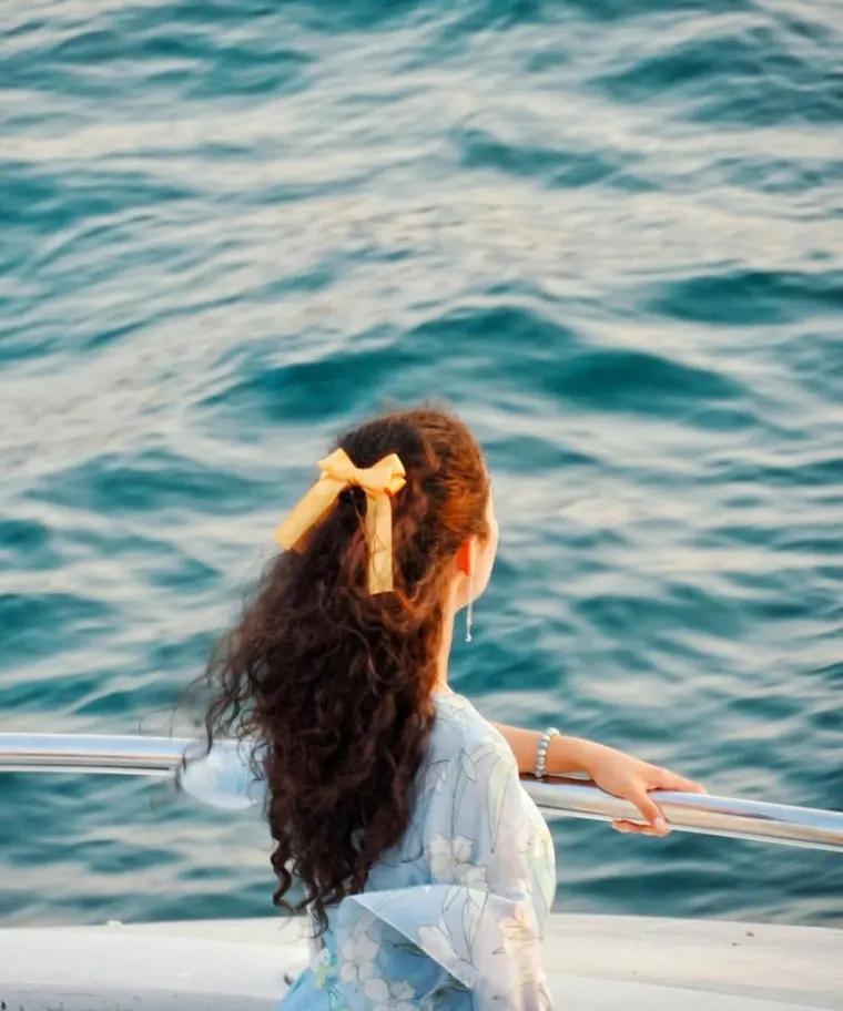 Woman enjoying the view of the sea from a boat